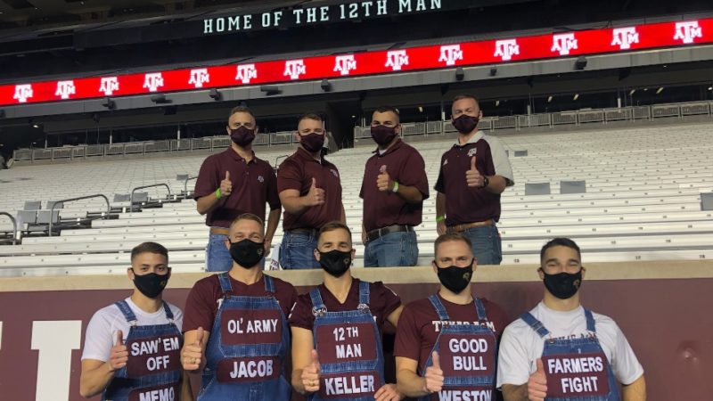 Texas A&M and Galveston Yell Leaders pose with thumbs up at Kyle Field after Midnight Yell on Oct. 30, 2020