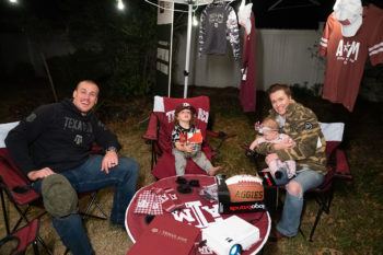 a photo of Max Kutch and his family decked out in free Aggie gear