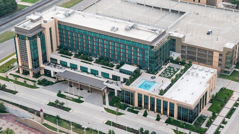 image of hotel with support aggieland overlay