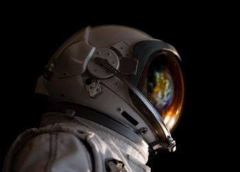 close up of astronaut with space reflected in helmet