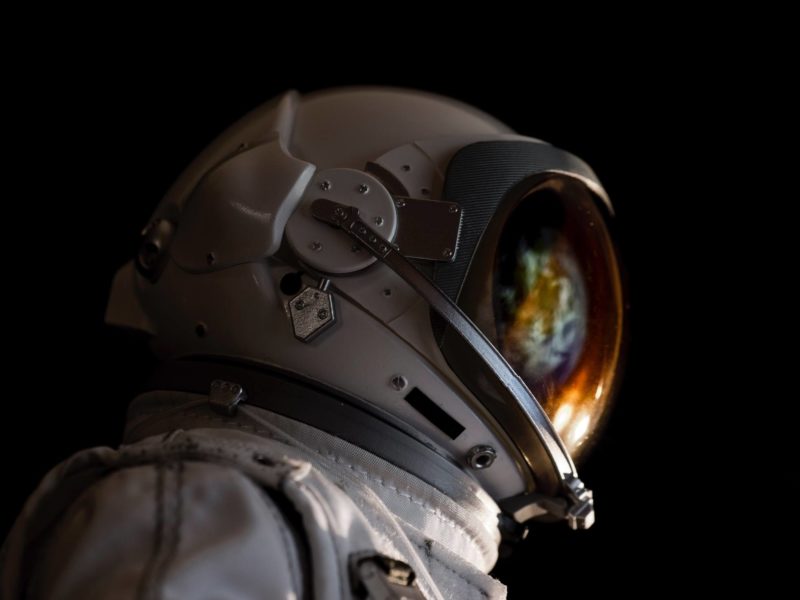 close up of astronaut with space reflected in helmet