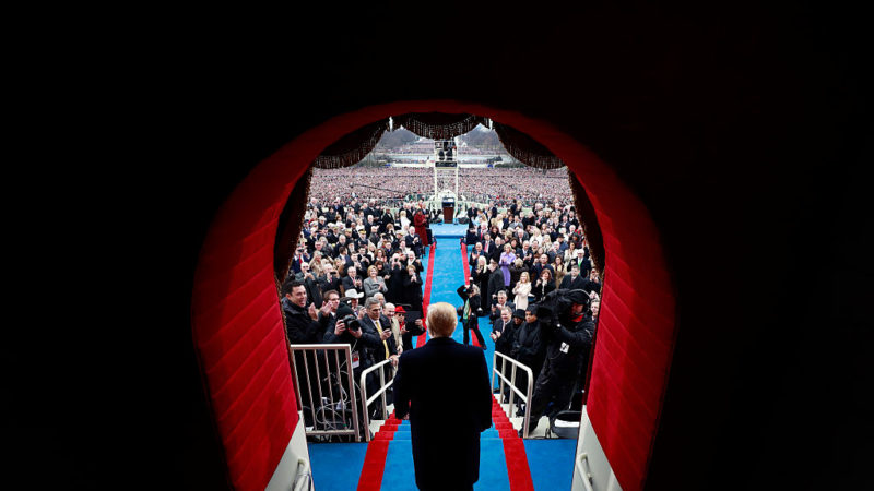 view from behind of donald trump walking into inauguration ceremony