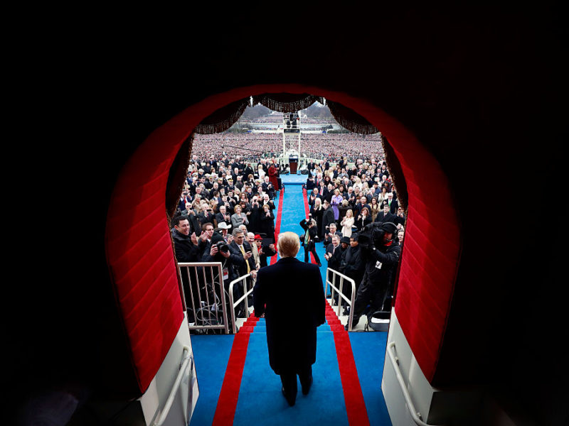 view from behind of donald trump walking into inauguration ceremony