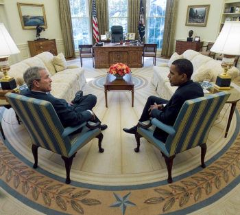 george w. bush and barack obama seated in the oval office