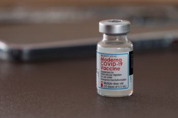 close up of a vial of the moderna covid-19 vaccine