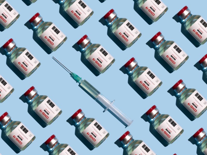 repeated vials and syringes against blue background