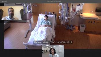 Screenshot showing two researchers on a screen along with a view of a patient room