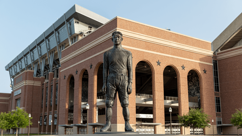 a photo of the E King Gill statue in front of Kyle Field