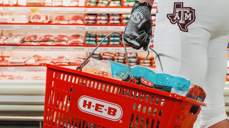 a photo of a Texas A&M football player shopping at H-E-B