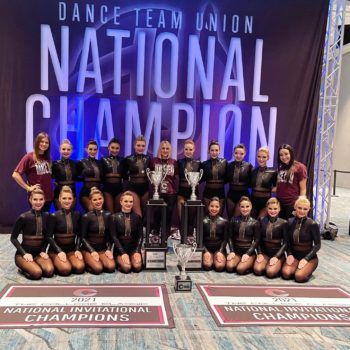 aggie dance team at the national championships with trophy
