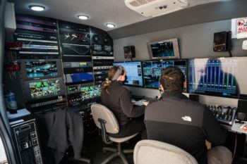 view of two employees sitting in KAMU van producing the livestream
