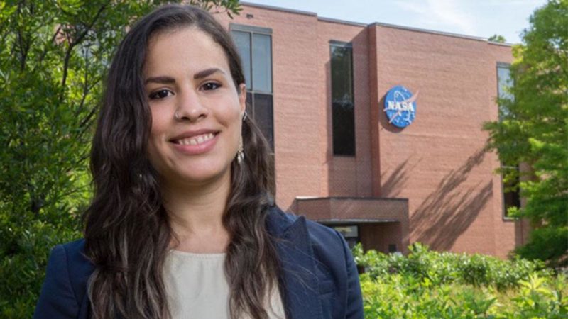 portrait of student standing in front of a building with the nasa logo