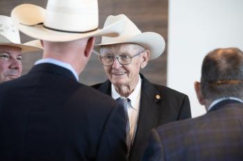 photo of men in cowboy hats talking at grand opening ceremony