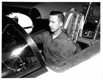 black and white photo of frazier seated in a cockpit