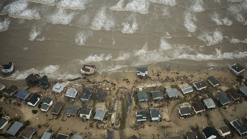 aerial photo of damaged beachfront homes on galveston island in front of the surf after hurricane ike