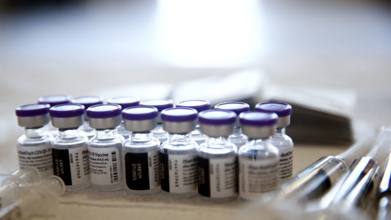 vials of the pfizer covid-19 vaccine set out on a table
