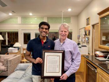 photo of sunjay letchuman next to leonard berry holding a framed copy of their paper