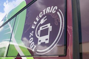 a closeup of an image on the bus that says 100 percent electric