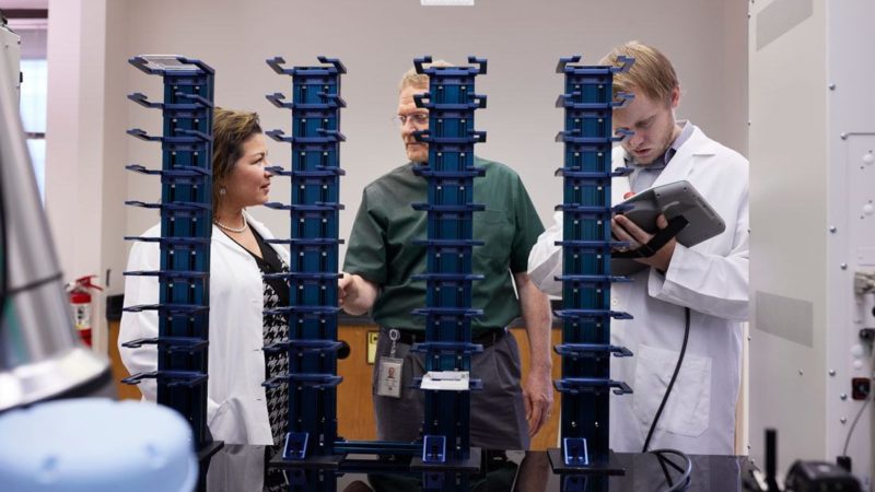 photo of three people in a research lab