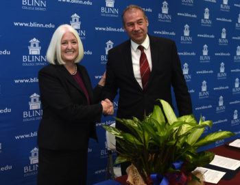 Patrick J. Stover, Ph.D., vice chancellor of Texas A&M AgriLife, dean of the College of Agriculture and Life Sciences, director of Texas A&M AgriLife Research, shakes hands with Mary Hensley, Ed.D., chancellor of the Blinn College District, at the signing of the agreement with Blinn