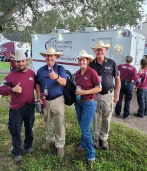 group photo of four people wearing cowboy hats at the operation lone star site