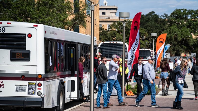 people step off buses on the texas a&m campus
