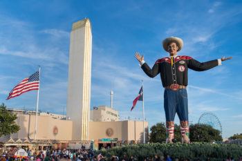 the big tex statue stands outside of the state fair of texas fairgrounds