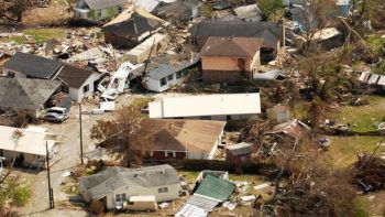 overhead view of destroyed houses in neighborhood after hurricane