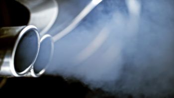 close up of smoke coming out of a car exhaust pipe