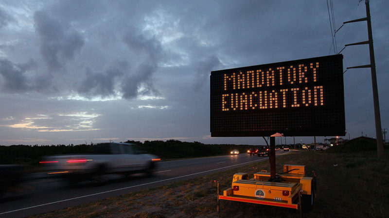 a highway sign warns motorists of mandatory evacuation
