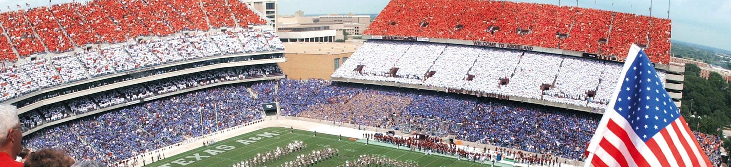image of fans at kyle field for the original red white and blue game