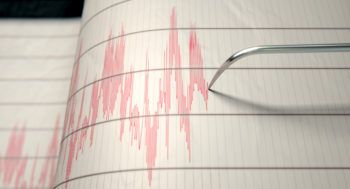 red ink lines on sheet of paper recorded by a seismograph needle