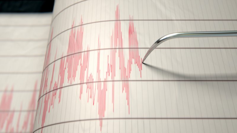 red ink lines on sheet of paper recorded by a seismograph needle