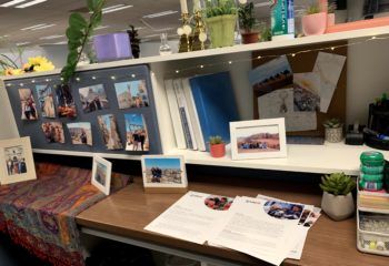 photo of a desk with shelves covered in documents and photos