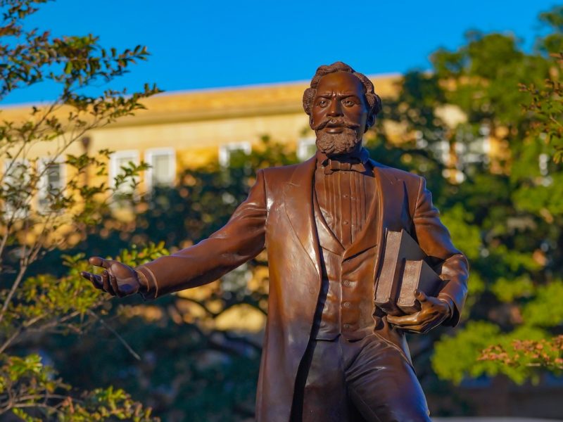 bronze statue of matthew gaines on campus