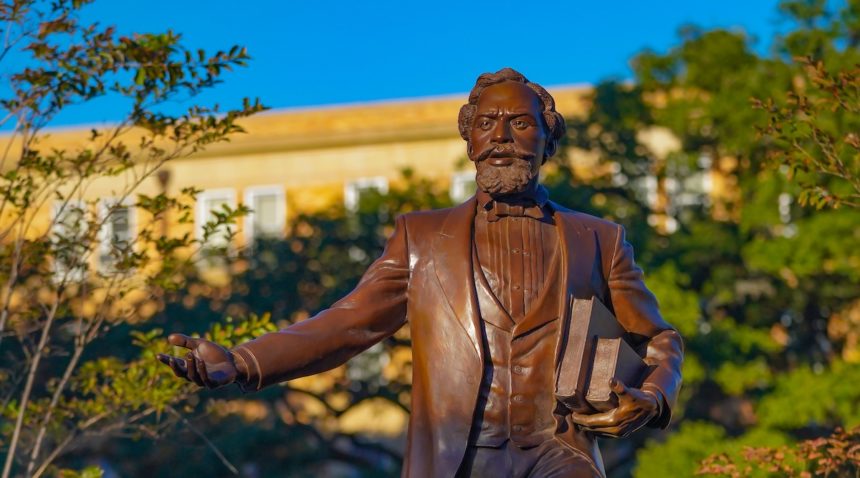 bronze statue of matthew gaines on campus