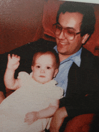 a man holding a baby on his lap