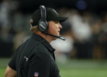Jon Gruden standing on sidelines at a game
