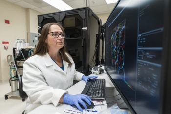 Malea Murphy, manager of the Integrated Microscopy and Imaging Laboratory, uses a multiphoton microscope at the Olympus Discovery Center at Texas A&M Health Science Center