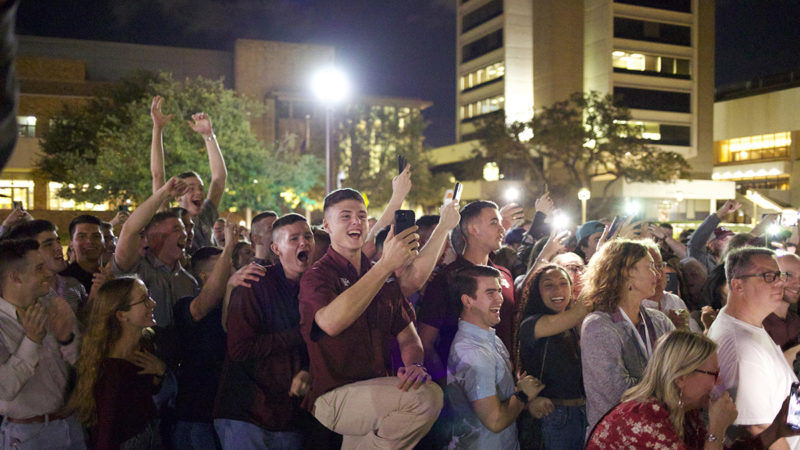 a crowd of Aggies celebrate the victors in the student elections at Kyle Field Plaza March 4, 2022