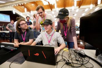 students look at a computer monitor