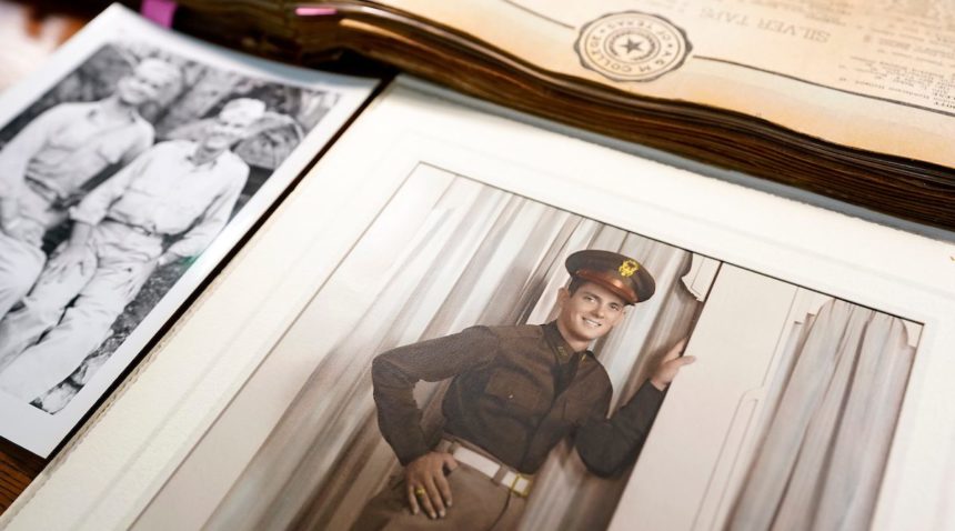 photos and documents are spread out on a table. the photo in focus is a colorized portrait of a man in a texas a&m corps of cadets uniform