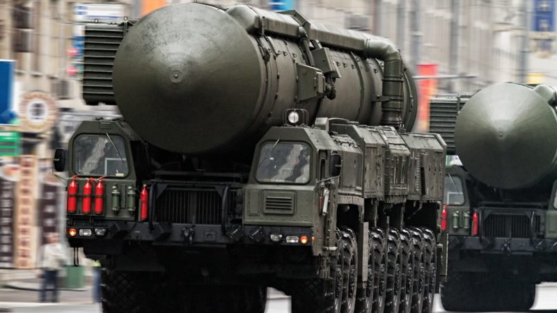 a photo of a Russian military truck carrying a nuclear missile through the streets of Moscow as another follows close behind