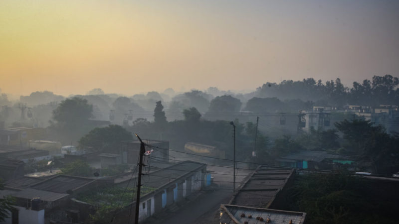 smog lies over a residential neighborhood in india