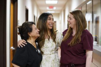 Texas A&M University student Andrea Nuñez stands between Diana Bigley, LVN, and Claire Kolb, a board certified physician assistant, at Student Health Services (SHS), the on-campus healthcare provider for Texas A&M University students, at the A.P. Beutel Health Center on April 12, 2022.