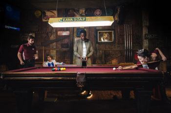 a still from the Where You Belong advertisement with Aggies playing pool