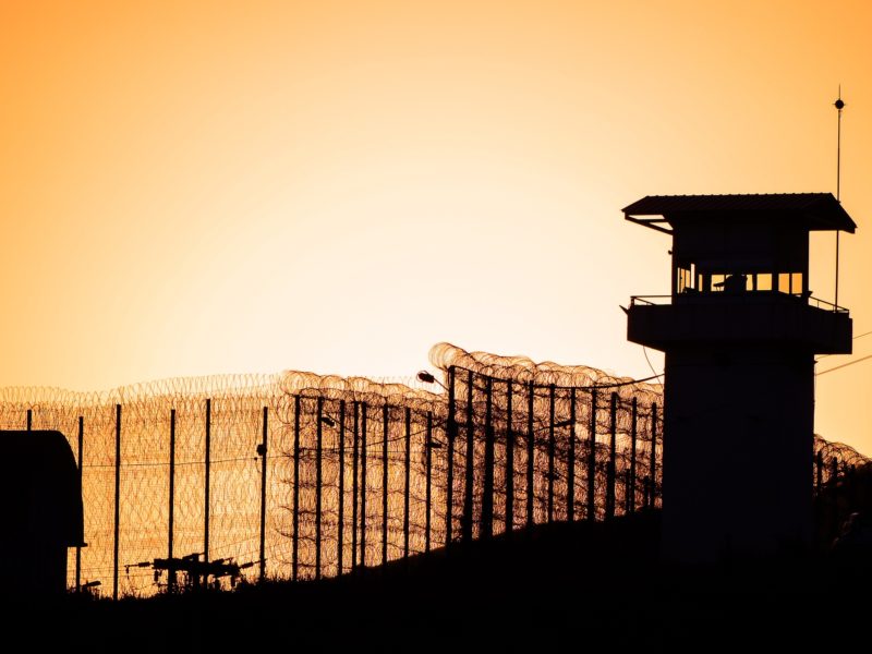 Stock image of the exterior of a prison at sunset