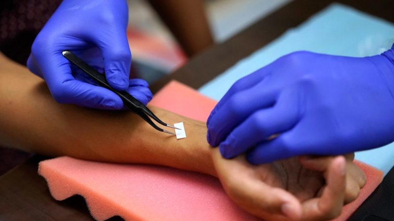 close up image of the e-tattooo being applied to a person's wrist