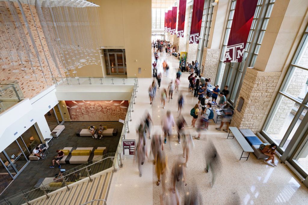 Image of blurred students walking through the student center