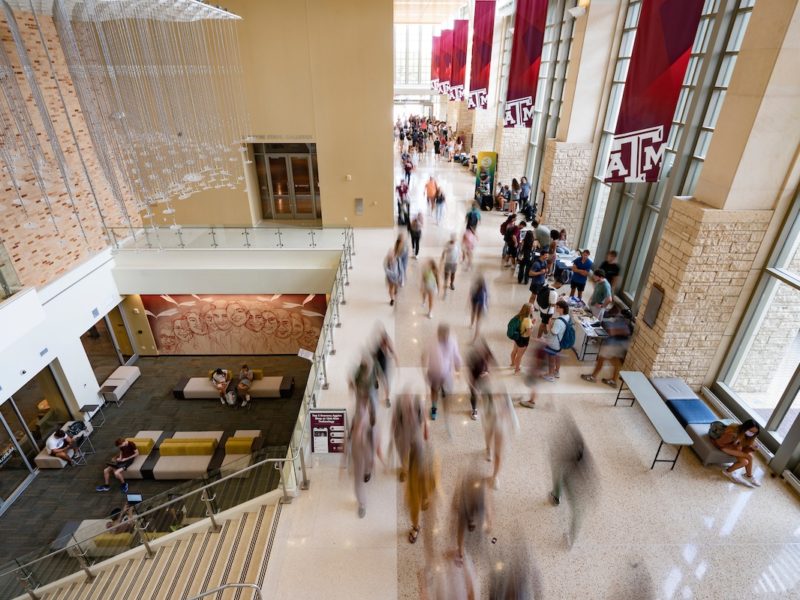 Image of blurred students walking through the student center